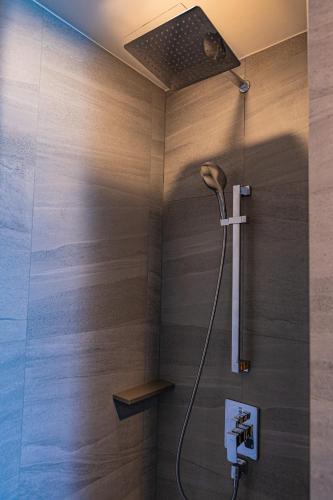 a shower with a shower head in a bathroom at Edge Central Pattaya Sea View in Pattaya