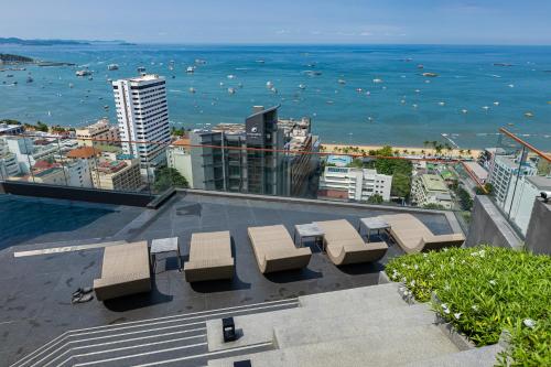 a group of benches sitting on top of a building at Edge Central Pattaya Sea View in Pattaya