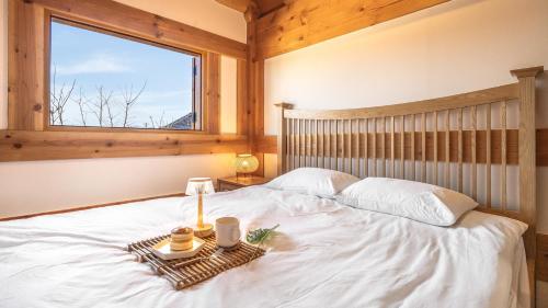 a bedroom with a bed with a tray of food on it at Gyeongju Hanokstay Darak in Gyeongju