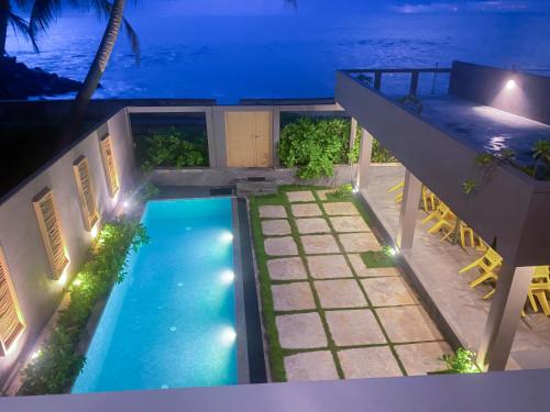 an overhead view of a house with a swimming pool at night at Villa Sea Queen in Ambalangoda