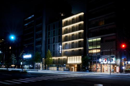 a building on a city street at night at hotel MONday KYOTO MARUTAMACHI in Kyoto