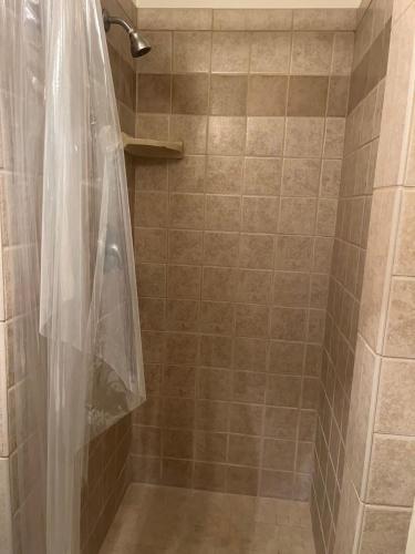 a shower with a clear shower curtain in a bathroom at Van Nuys Homes for the Soul in Los Angeles