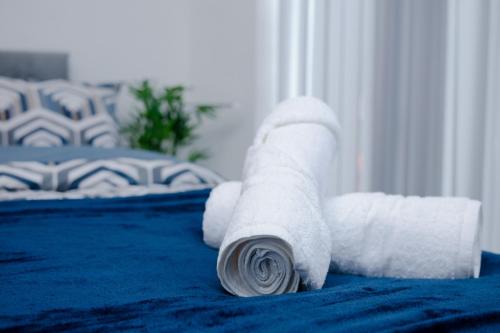 a roll of toilet paper on a bed at Grace Double Bedroom Manchester in Middleton