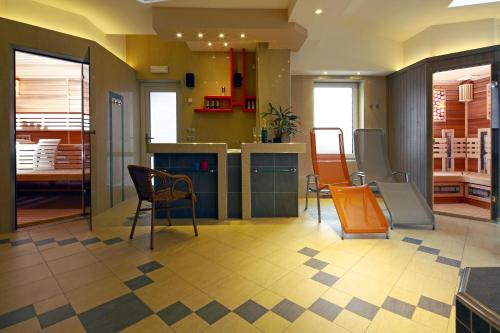 a kitchen with chairs and a table in a room at Wellness Penzion Pod Rozhlednou in Kostelec nad Orlicí