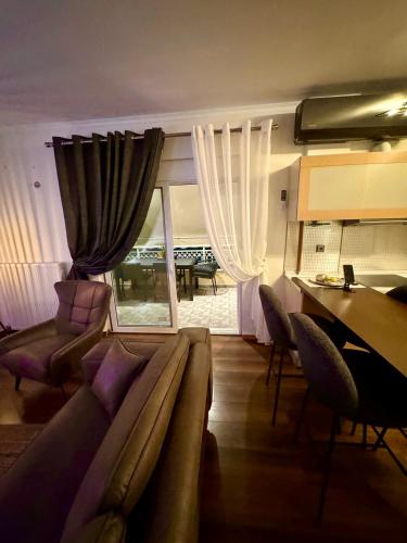 a living room with a couch and a table at LUXE COASTAL RETREAT Apartment in Alexandroupoli