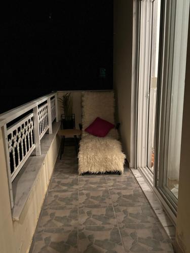 a hallway with a rug on the floor next to a window at LUXE COASTAL RETREAT Apartment in Alexandroupoli