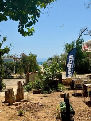 a group of tables and chairs and a sign at LUXE COASTAL RETREAT Apartment in Alexandroupoli