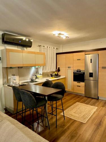 a kitchen with a table and chairs and a refrigerator at LUXE COASTAL RETREAT Apartment in Alexandroupoli
