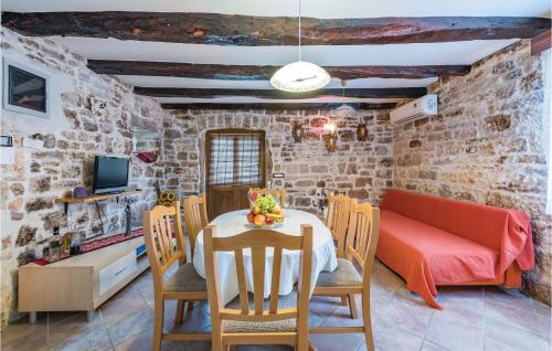 a dining room with a table and chairs and a couch at Lovely Home In Visnjan With Wifi in Višnjan