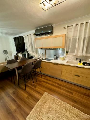 a kitchen with a table and chairs and a dining room at LUXE COASTAL RETREAT Apartment in Alexandroupoli