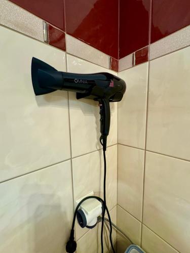 a blow dryer is hanging on a wall at LUXE COASTAL RETREAT Apartment in Alexandroupoli
