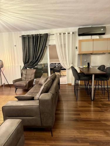 a living room with a couch and a table at LUXE COASTAL RETREAT Apartment in Alexandroupoli
