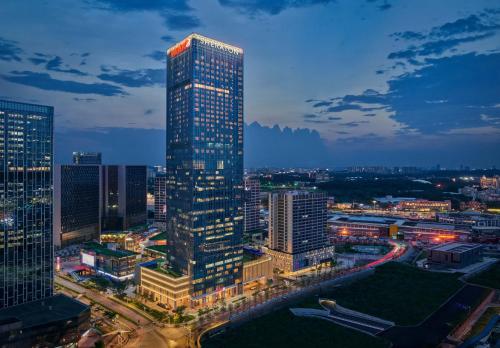 a tall building in a city at night at Sheraton Guangzhou Panyu in Guangzhou