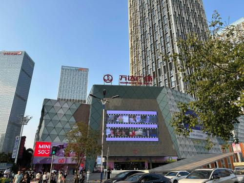 a building with a sign on it in a city at Sheraton Guangzhou Panyu in Guangzhou
