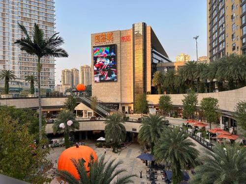 a city with a large building and palm trees at Sheraton Guangzhou Panyu in Guangzhou