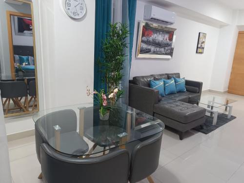 a living room with a couch and a glass table at Simply the most comfortable place next to Boca Chica beach in Boca Chica