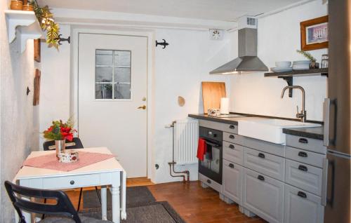 a small kitchen with a table and a stove at 1 Bedroom Amazing Apartment In Ystad in Ystad