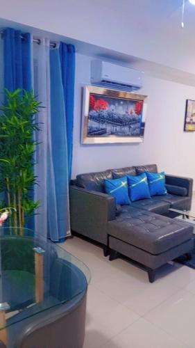 a living room with a couch with blue pillows at Simply the most comfortable place next to Boca Chica beach in Boca Chica