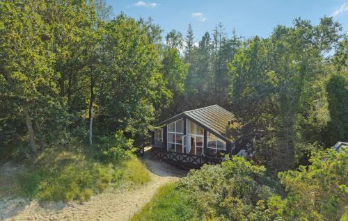 a small cabin in the middle of a forest at Cozy Home In Børkop With Wifi in Børkop