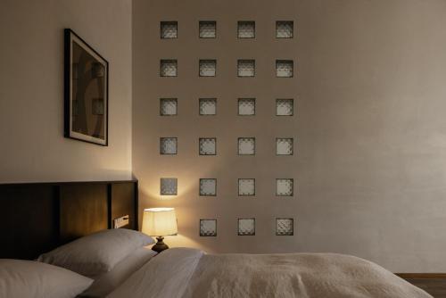 a bedroom with a wall with pictures on the wall at 大理空岛半山海景民宿 in Dali