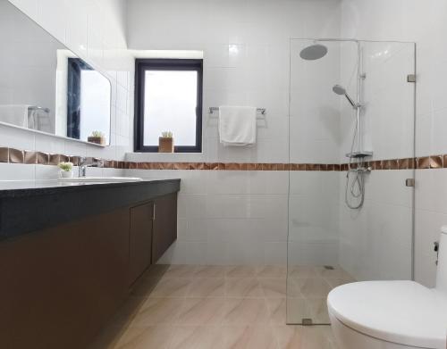 a bathroom with a shower and a toilet and a sink at Krabi Private Pool Villa 2 by Belcarra Spaces in Ban Khlong Haeng
