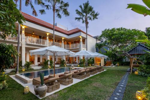 an exterior view of a villa with a swimming pool at KALM Bali in Canggu