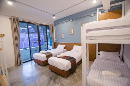 Postel nebo postele na pokoji v ubytování Suree House