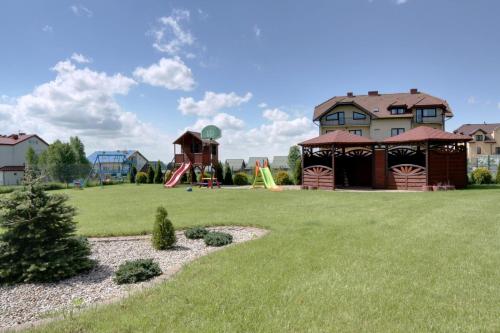 a yard with a playground and a house at Domki Letniskowe Błękit in Jastrzębia Góra
