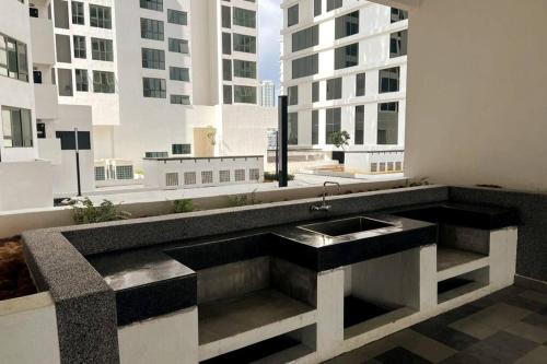 a bathroom with a sink in the middle of a building at Edumetro B32 3 Bedroom Subang Sunway By MICASA GROUP in Subang Jaya