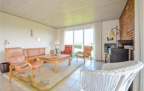 a living room with a couch and a table and chairs at Three-Bedroom Holiday Home In Hurup Thy in Doverodde