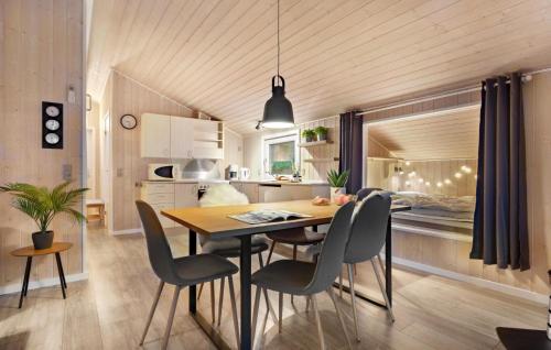a kitchen and dining room with a table and chairs at Two-Bedroom Holiday Home In Toftlund in Toftlund