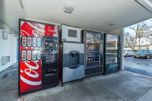 two cocacola machines are parked in a gas station at Motel 6 Hayward, CA- Silicon Valley Gateway in Hayward