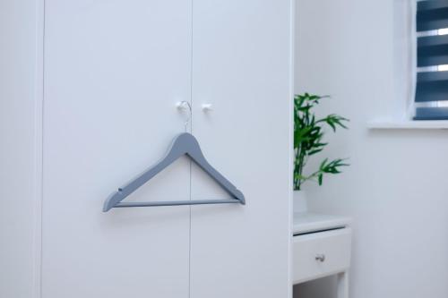 a hanger hanging on a white wall in a room at Glory Double Bedroom Manchester in Middleton