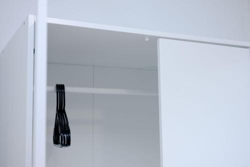 a whisk hanging on a shelf in a kitchen at Glory Double Bedroom Manchester in Middleton