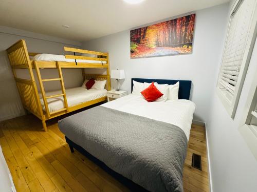 a bedroom with two bunk beds and a ladder at Private Hot Tub - Private Front Yard with Mountain View Patio in Canmore