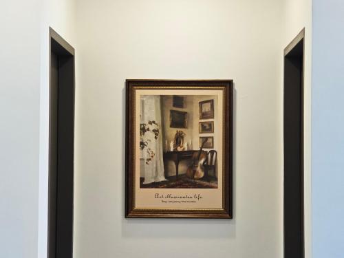 a picture hanging on a wall in a room at D'pristine by Antlerzone in Johor Bahru