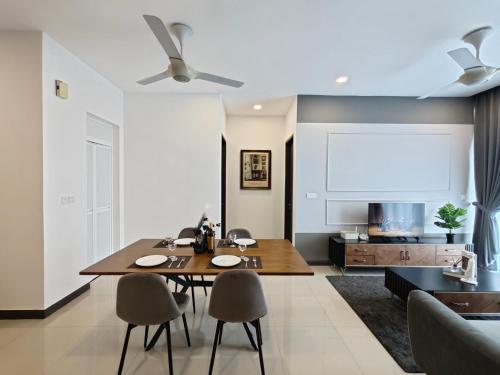 a dining room with a table and chairs and a couch at D'pristine by Antlerzone in Johor Bahru