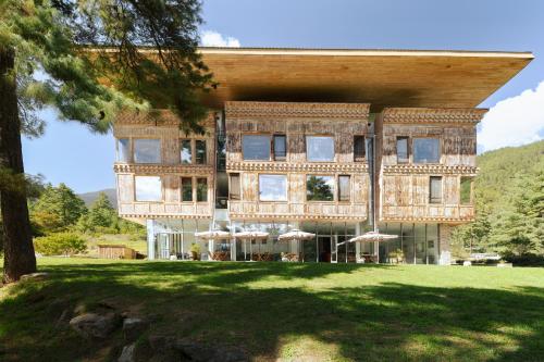 a large brick building with umbrellas in a park at Zhiwaling Ascent in Thimphu