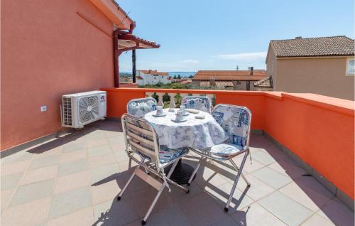 a table and chairs on the balcony of a house at Holiday Apartment Betiga 2 in Barbariga