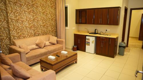 a living room with a couch and a table at هذه ليلتي- اليرموك- طريق الدمام This Lailaty Al Yarmouk-Dammam Road in Riyadh