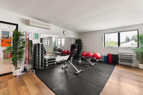 a gym with red chairs and equipment in a room at YHA Brisbane City in Brisbane