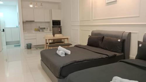 a bedroom with a bed with two towels on it at Chambers Residence by Gloria Homes in Kuala Lumpur