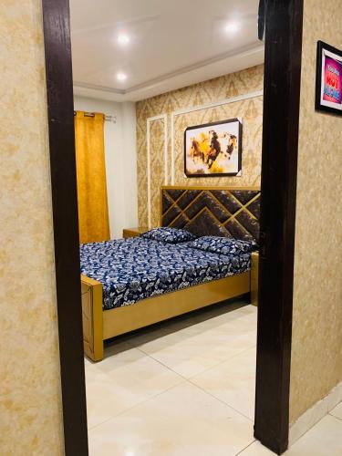 a bedroom with a bed in a room at Apartment in Lahore Bahria town near Effiel tower in Rāmkot