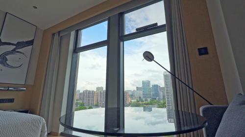 a room with a glass table in front of a window at Fairfield by Marriott Hangzhou Qiantang in Hangzhou