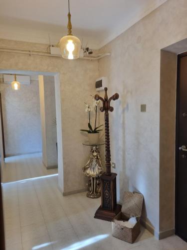 a room with a cross on the wall and a room with a chair at Apartament ultracentral Classic Vibe in Craiova