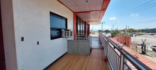 a balcony of a building with a tv on the wall at SID'S Traveller's INN in General Santos
