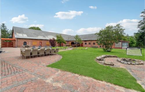 a courtyard with chairs and a building at Lovely Home In Sæby With Sauna in Sæby