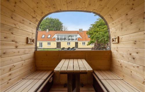 an empty room with a table and a window at Lovely Home In Sæby With Sauna in Sæby