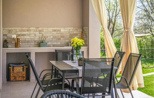 a dining room with a table and chairs at Gorgeous Home In Radeki Glavica in Loborika