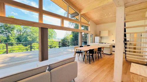 a large living room with a table and chairs at Terrace Villa Foresta Asama in Miyota